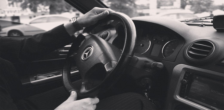 Man at the wheel of car